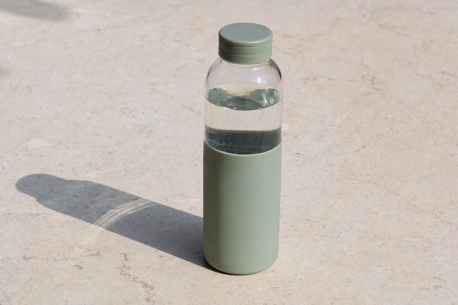 Clear 550 glass bottle with sage sleeve shown upright