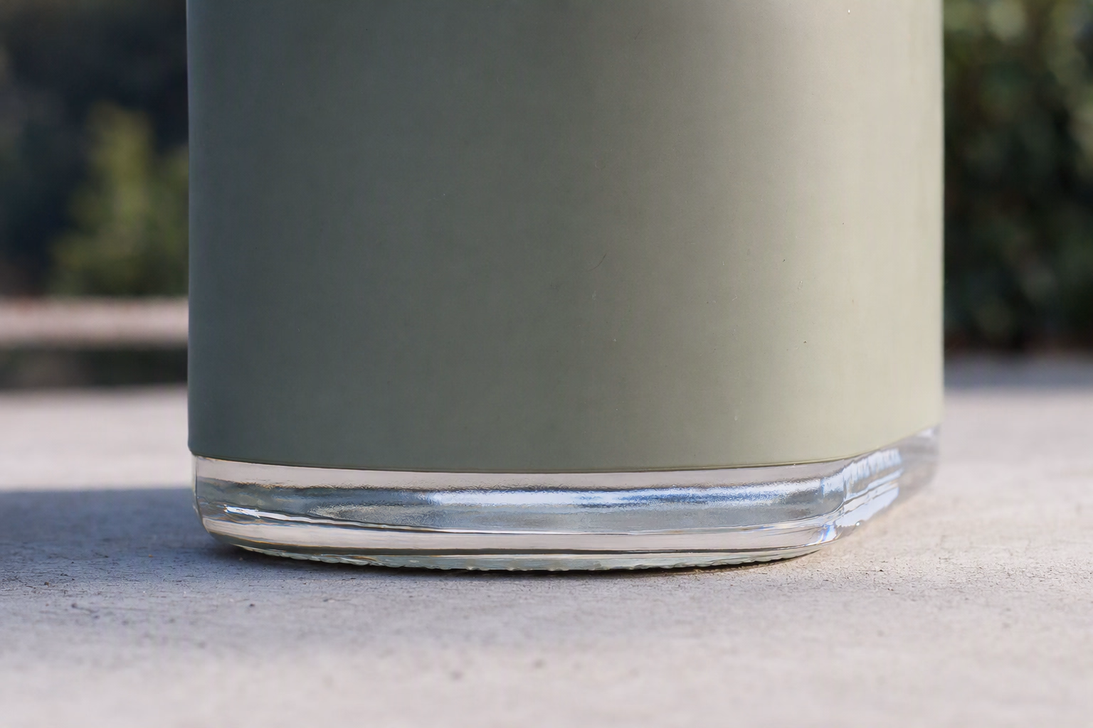 Close view of the glass bottle base seated in its sleeve