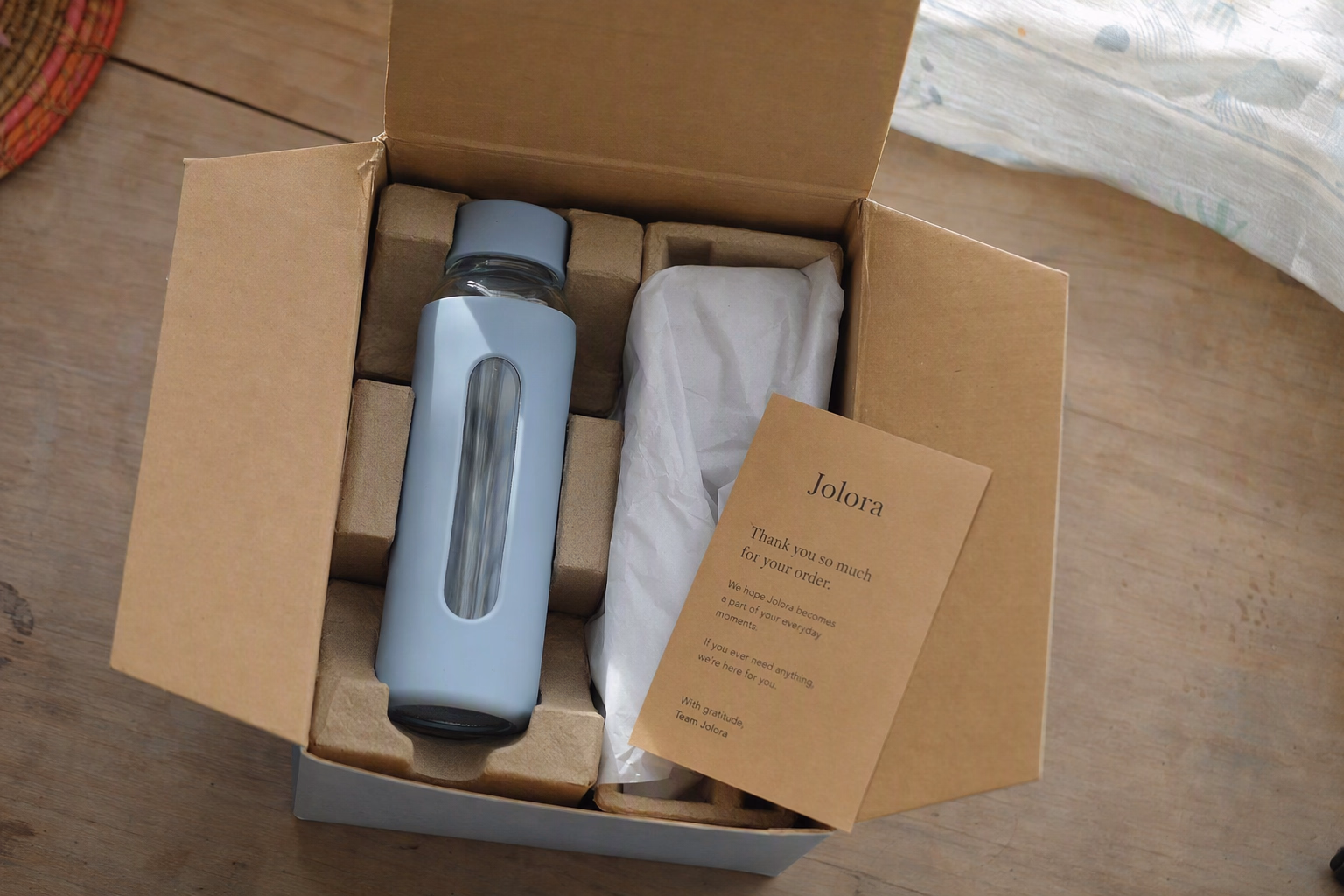 Opened Jolora bottle parcel being carefully inspected