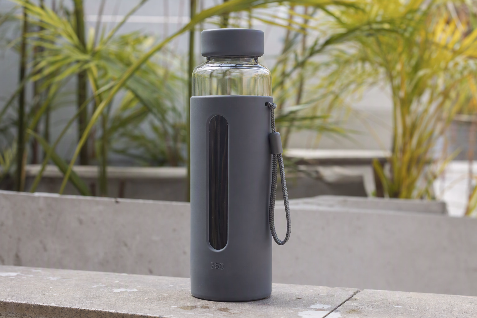 Tall Active 750 glass bottle in a graphite protective sleeve
