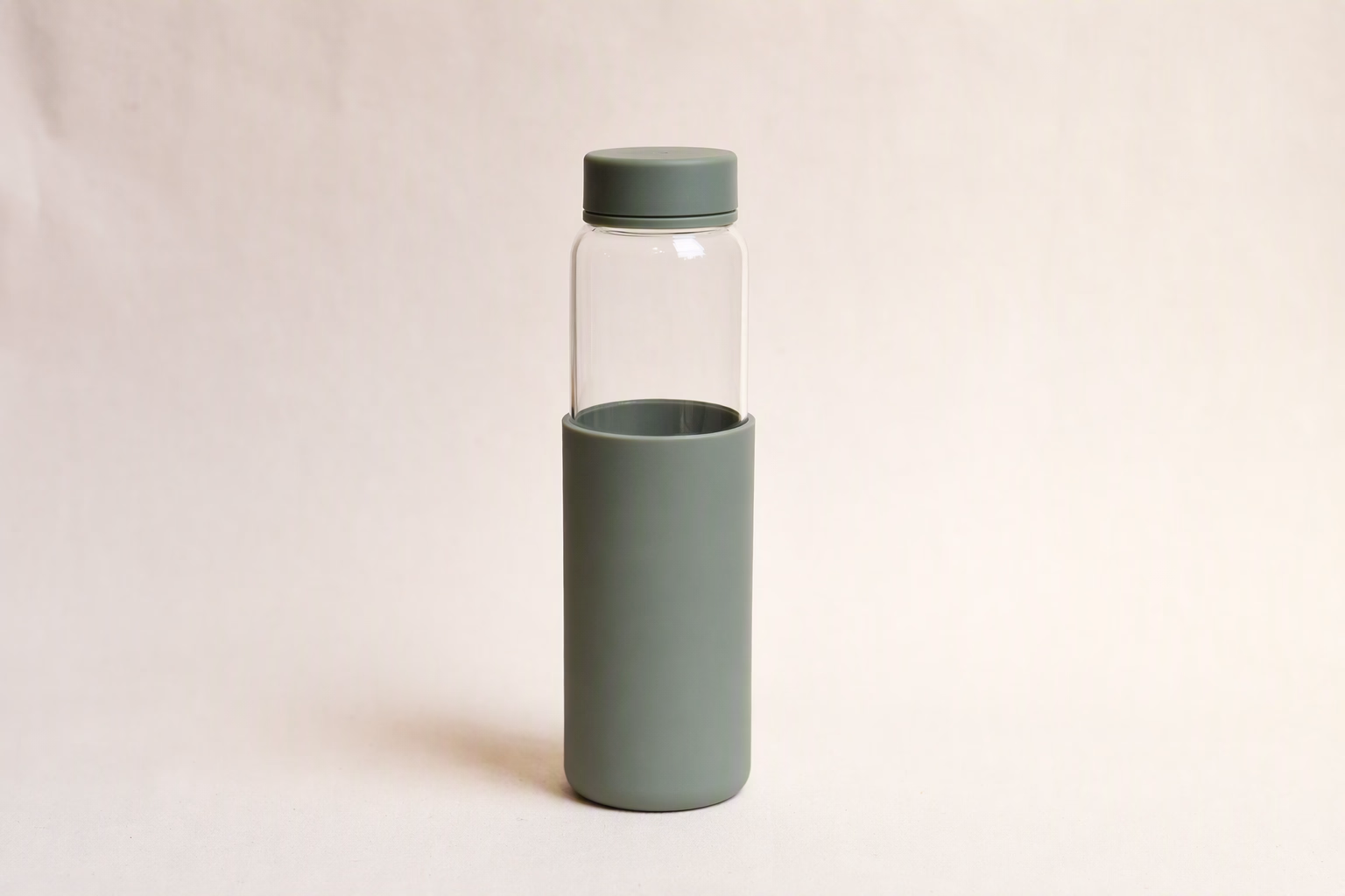 Clear 550 glass bottle with a sage silicone sleeve